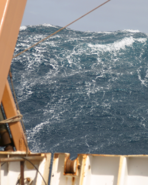 Large but non-fatal wave towering above the stern of the  U.S. government research vessel <i>Delaware II</i> in the northern Atlantic Ocean
