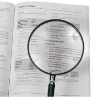 Magnifying glass enlarges the text of the book