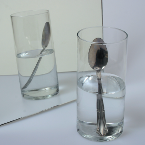 Reflection of a glass of water and spoon